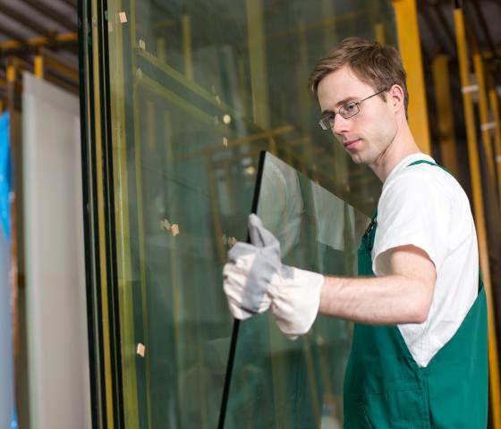 Decorative Image - Man holding glass pane